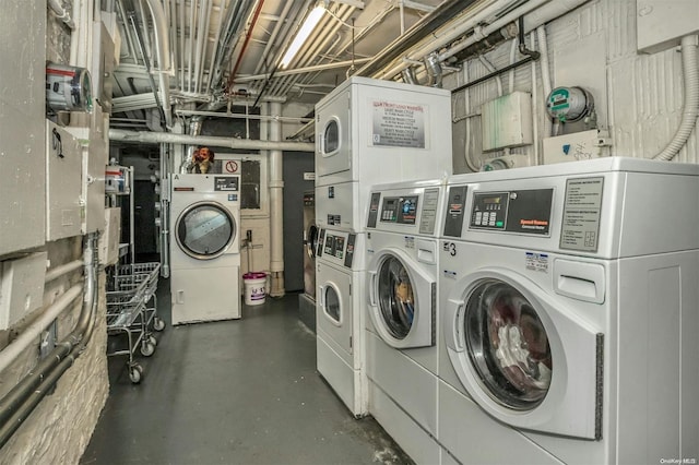 washroom with washing machine and clothes dryer and stacked washing maching and dryer