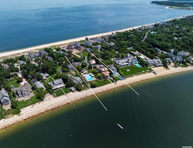 birds eye view of property with a beach view and a water view