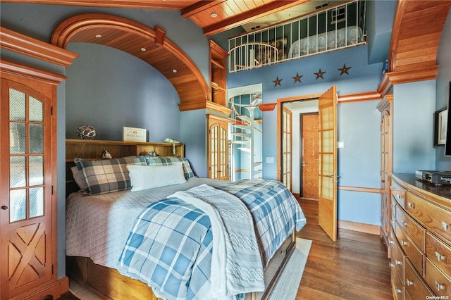 bedroom with french doors, lofted ceiling with beams, hardwood / wood-style flooring, and wood ceiling