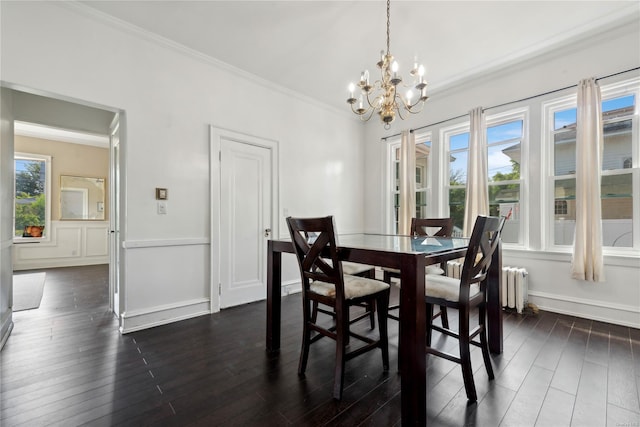 dining room with radiator, crown molding, dark wood-type flooring, and an inviting chandelier