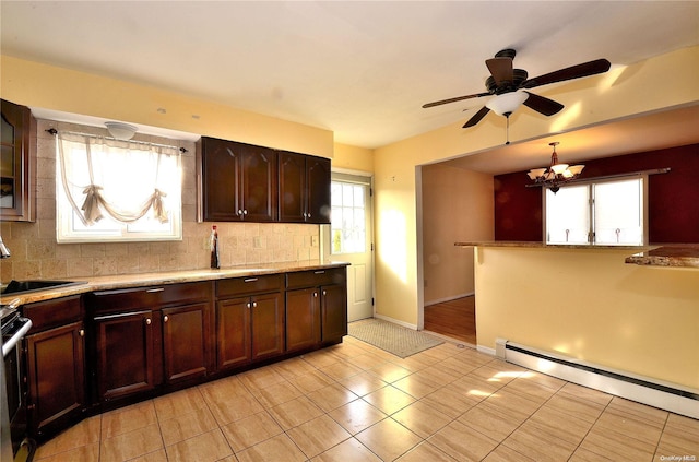 kitchen with decorative backsplash, a healthy amount of sunlight, and a baseboard radiator