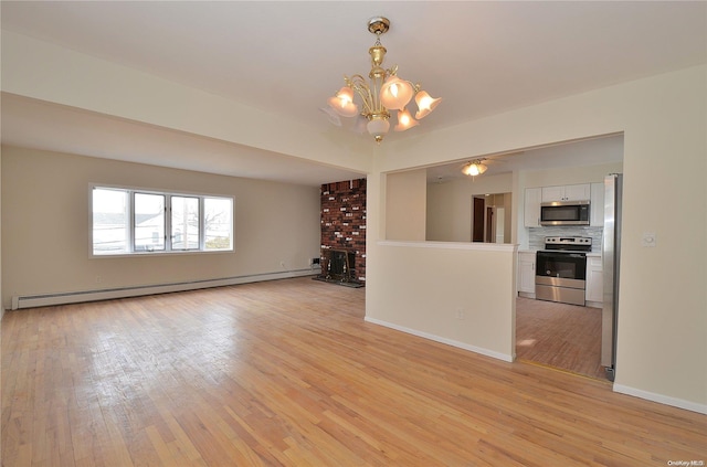 unfurnished living room featuring a fireplace, light hardwood / wood-style flooring, a baseboard radiator, and an inviting chandelier