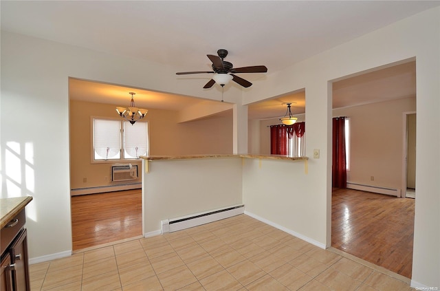 empty room featuring light hardwood / wood-style floors and a baseboard heating unit