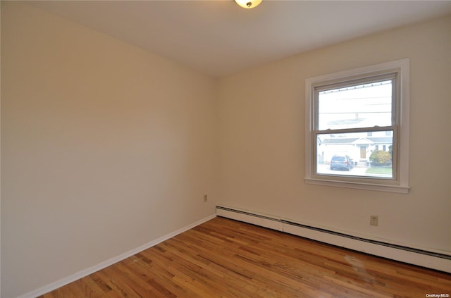 spare room featuring light hardwood / wood-style flooring and a baseboard radiator