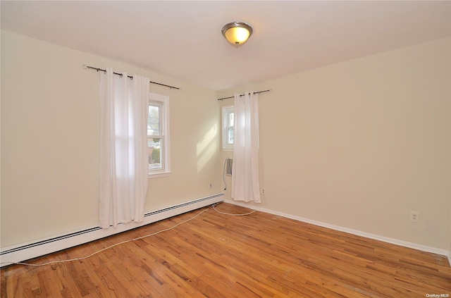 spare room featuring light hardwood / wood-style flooring and a baseboard radiator