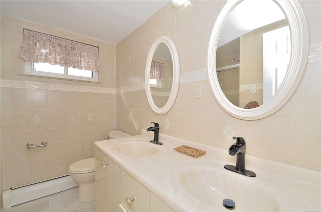 bathroom with vanity, a baseboard radiator, tile walls, and toilet