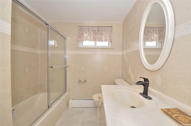 full bathroom with vanity, toilet, shower / bath combination with glass door, and tile walls