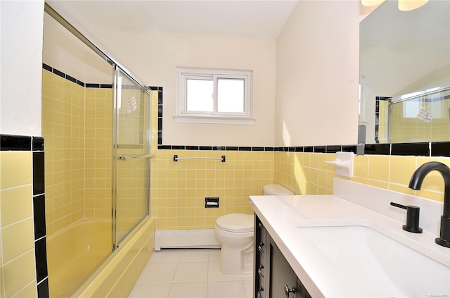 full bathroom featuring bath / shower combo with glass door, a baseboard radiator, tile walls, tile patterned flooring, and toilet