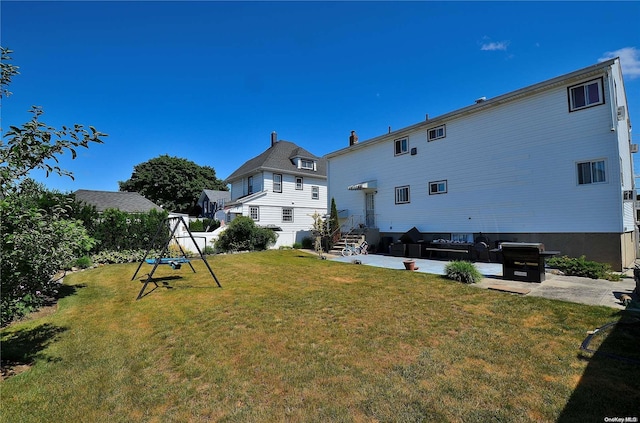 back of house featuring a lawn and a patio