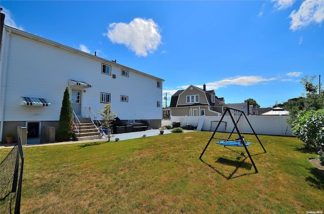 rear view of house featuring a lawn