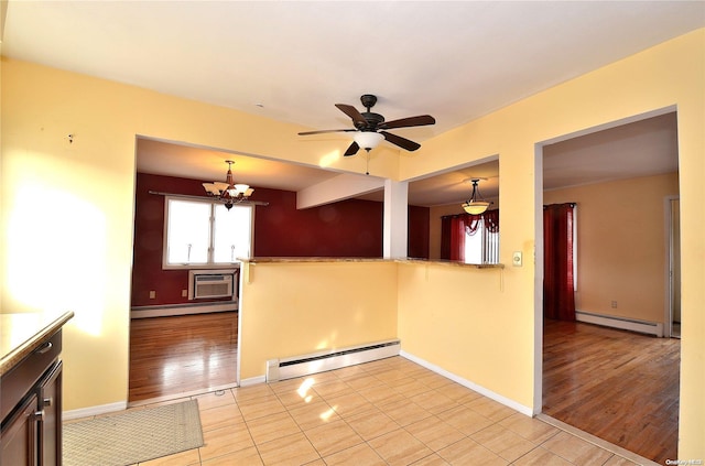 interior space featuring decorative light fixtures, light hardwood / wood-style floors, and a baseboard heating unit