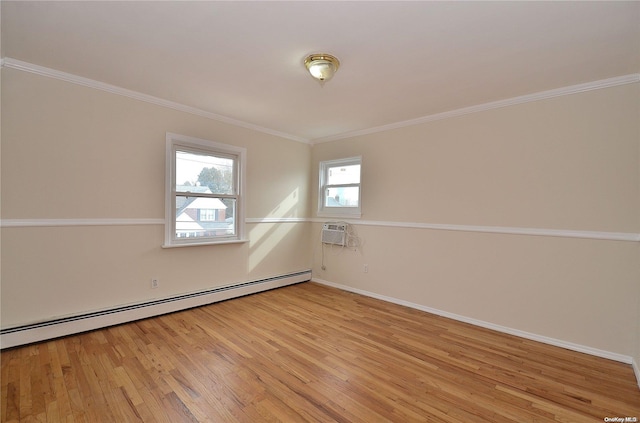 spare room featuring light wood-type flooring, baseboard heating, and ornamental molding