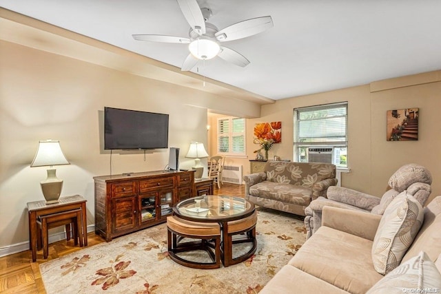 living room featuring parquet floors, radiator, cooling unit, and ceiling fan