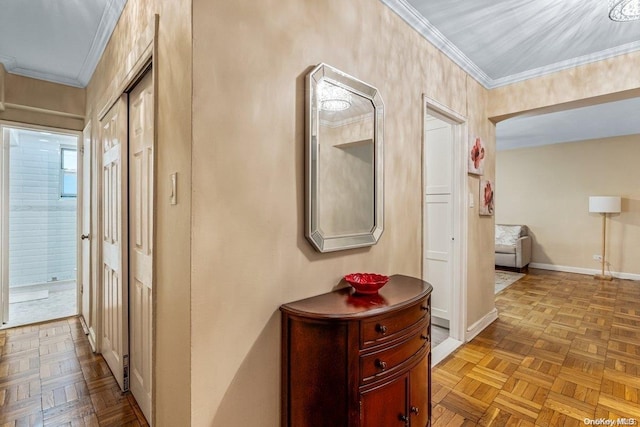 hallway with crown molding and light parquet floors