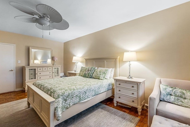 bedroom with ceiling fan and dark parquet floors