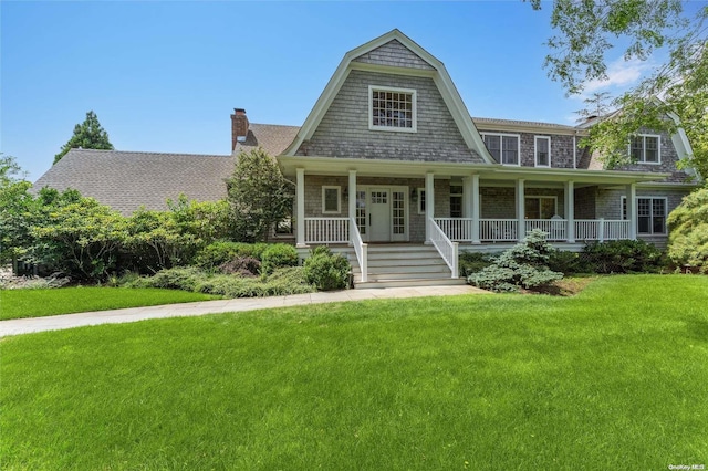 view of front of house with a front yard and a porch