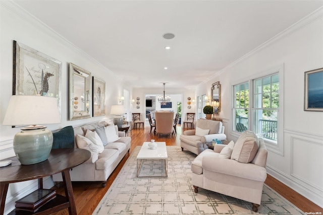 living room with wood-type flooring and ornamental molding