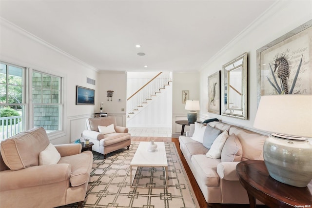 living room with light hardwood / wood-style floors and crown molding