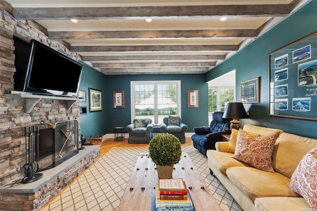 living room with beam ceiling, a fireplace, and hardwood / wood-style flooring