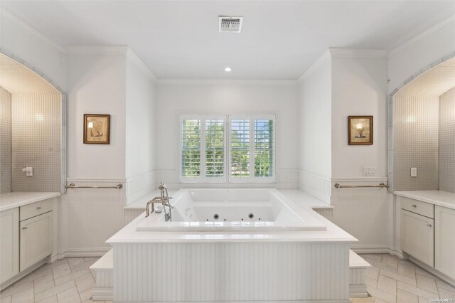 bathroom featuring vanity, a relaxing tiled tub, and ornamental molding