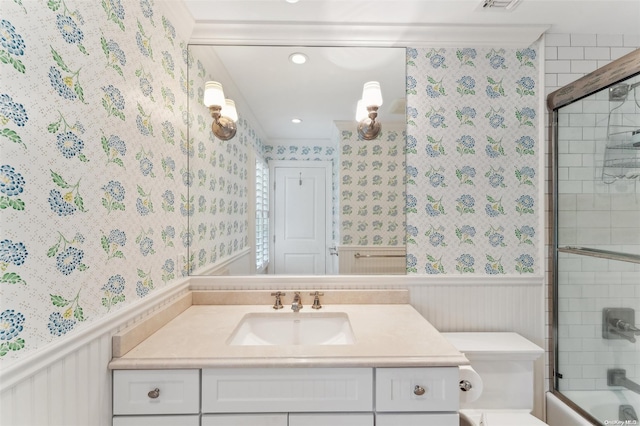 full bathroom featuring vanity, bath / shower combo with glass door, and toilet