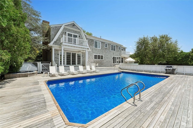 view of pool featuring grilling area and a wooden deck