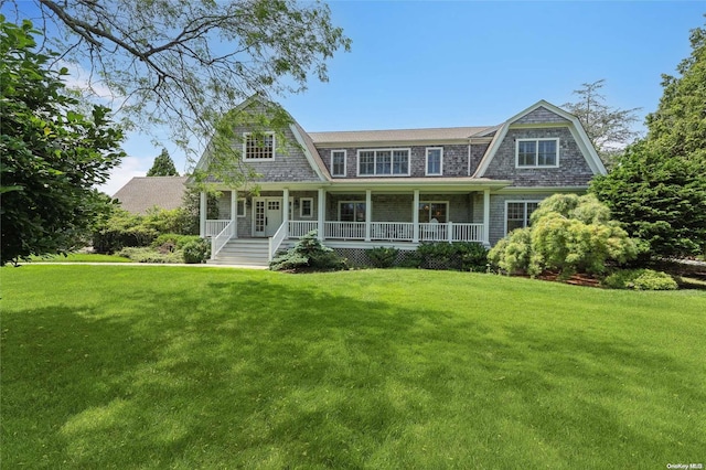 view of front of house featuring covered porch and a front lawn