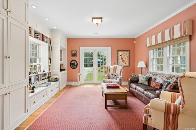 living room featuring french doors, light hardwood / wood-style flooring, and crown molding