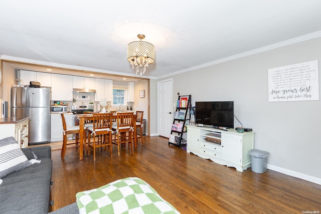 living room with a chandelier, dark wood-type flooring, and ornamental molding