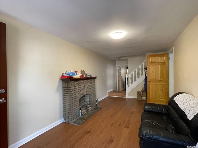 living room with hardwood / wood-style floors and a fireplace