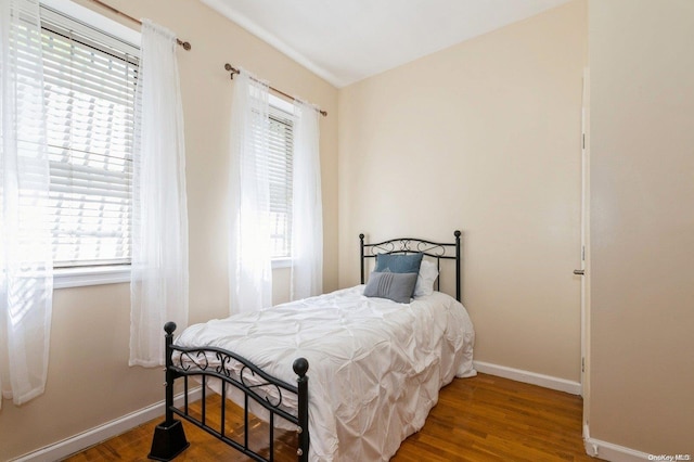 bedroom featuring wood-type flooring and multiple windows