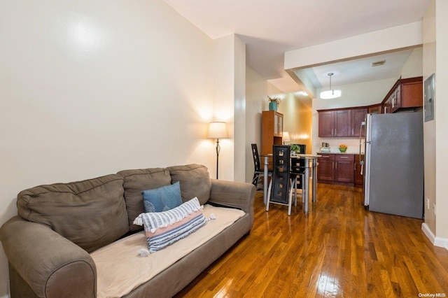 living room with dark wood-type flooring and electric panel