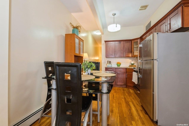 kitchen featuring decorative backsplash, stainless steel appliances, dark hardwood / wood-style floors, and hanging light fixtures