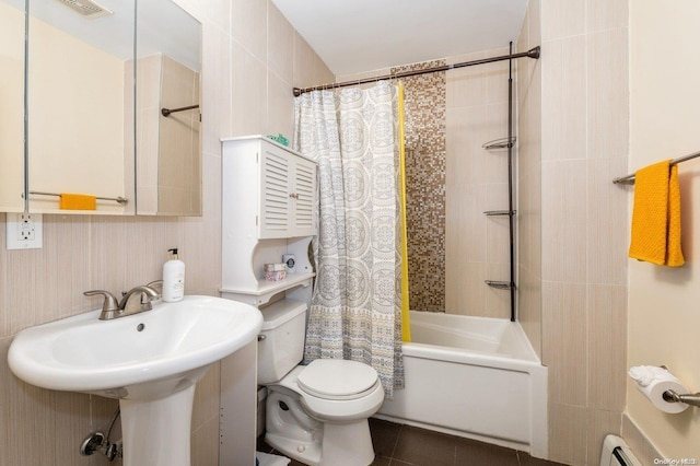 bathroom with tile patterned floors, toilet, a baseboard radiator, and shower / tub combo with curtain