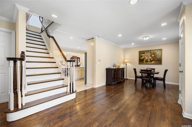 dining area with ornamental molding and hardwood / wood-style flooring