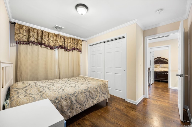 bedroom with dark hardwood / wood-style floors, ornamental molding, and a closet