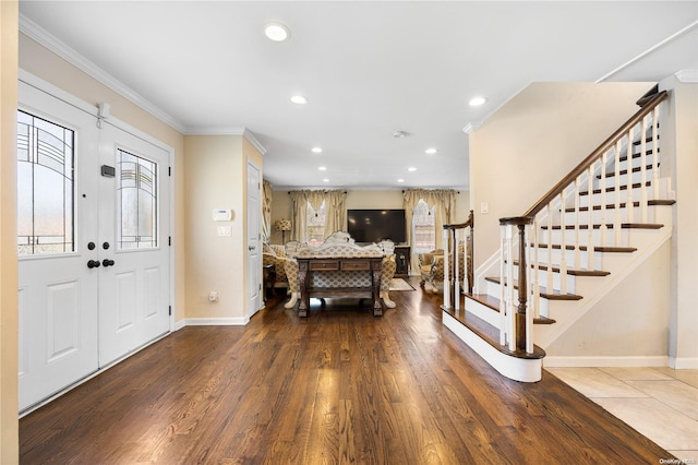 foyer with hardwood / wood-style flooring and ornamental molding