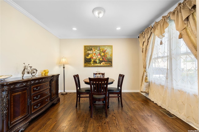 dining area featuring dark hardwood / wood-style floors and crown molding