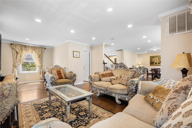 living room featuring wood-type flooring and crown molding