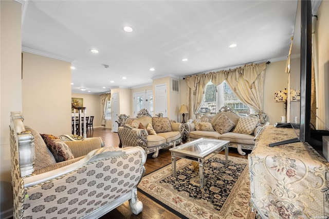 living room with wood-type flooring and crown molding