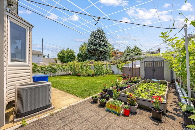 view of yard featuring central AC and a storage shed