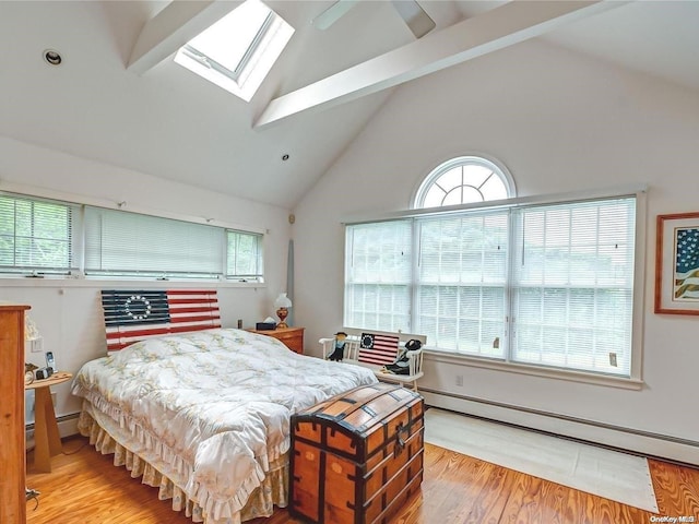 4 Landing Ln, Southampton, NY 11968 - bedroom featuring a skylight, wood finished floors, baseboard heating, multiple windows, and high vaulted ceiling