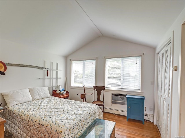 4 Landing Ln, Southampton, NY 11968 - bedroom featuring baseboard heating, light wood-type flooring, vaulted ceiling, and a wall mounted air conditioner