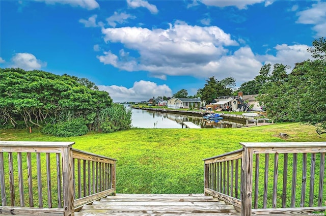 4 Landing Ln, Southampton, NY 11968 - view of green lawn with a deck with water view and a residential view