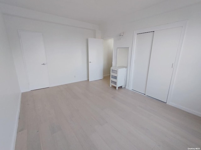 99-05 63rd Dr Unit 5O, Rego Park, NY 11374 - unfurnished bedroom with light wood-style floors and a closet