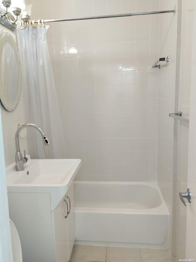 bathroom with tile patterned flooring, vanity, and shower / bath combination with curtain