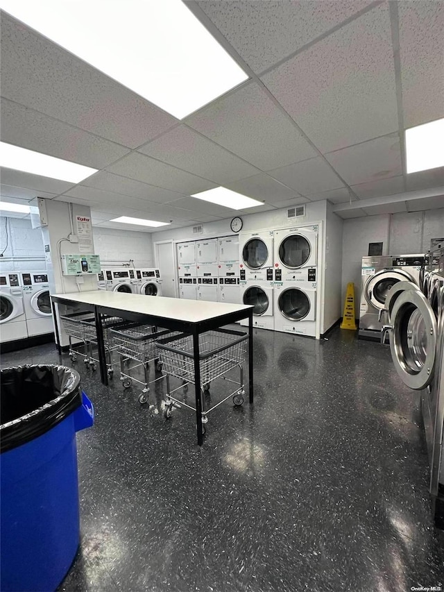 clothes washing area with washing machine and clothes dryer and stacked washing maching and dryer