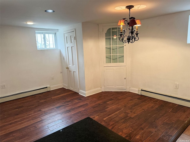 unfurnished dining area featuring a notable chandelier, dark hardwood / wood-style flooring, and a baseboard heating unit