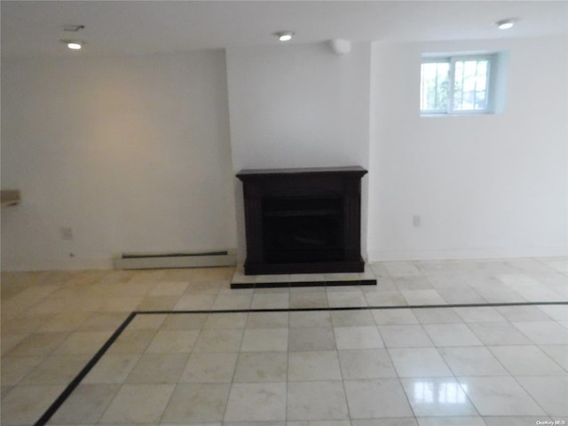 interior space with light tile patterned flooring and baseboard heating