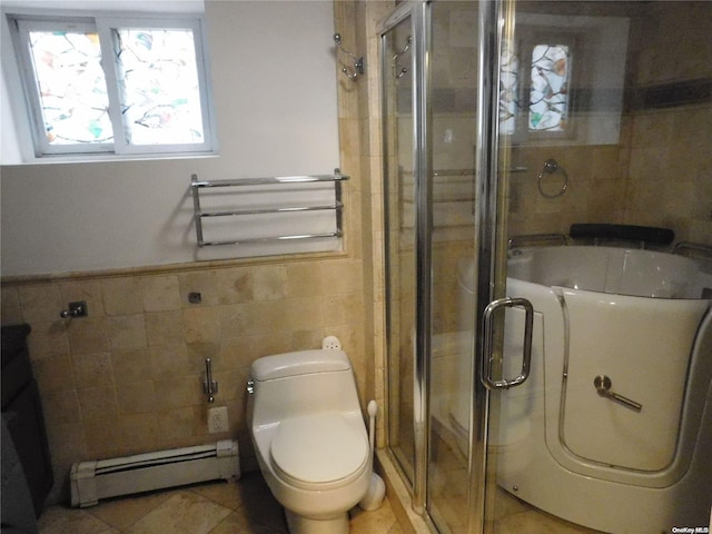 bathroom featuring a baseboard heating unit, tile patterned floors, toilet, tile walls, and washer / clothes dryer